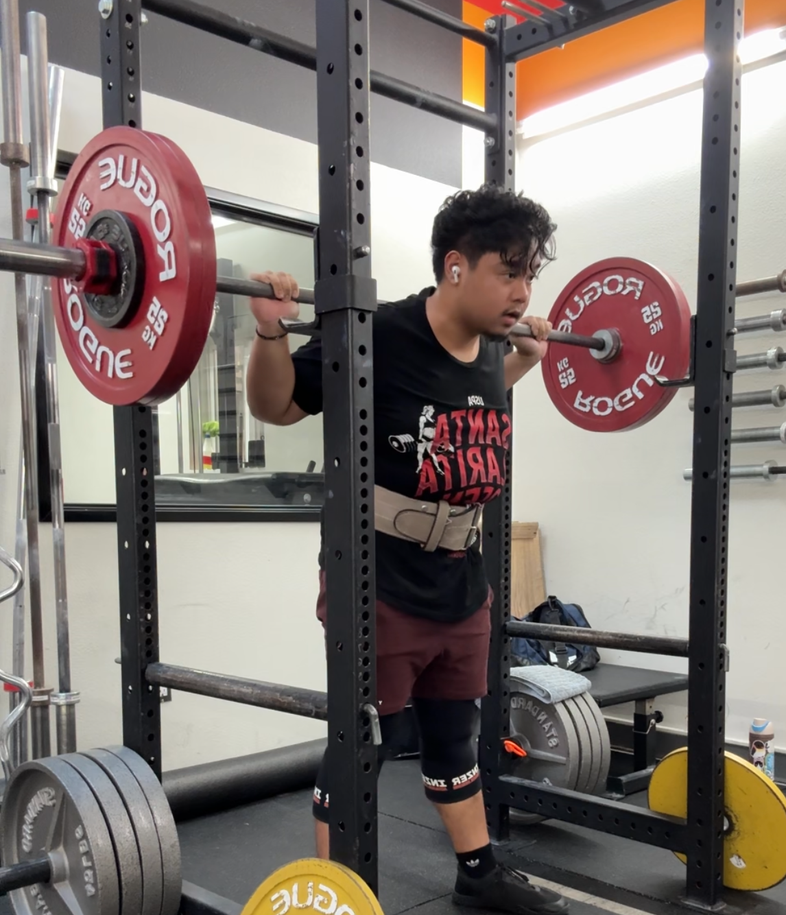 Founder performing a squat in the gym